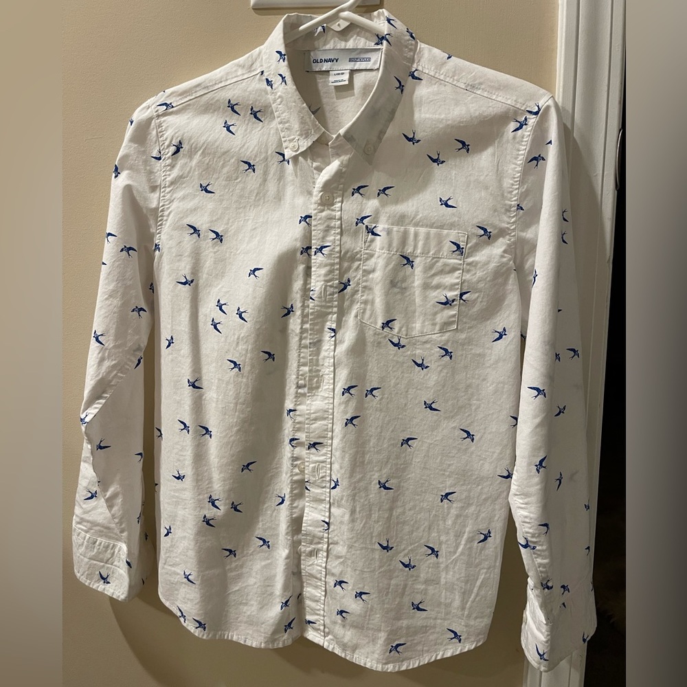 An old navy button down shirt for boys that is white with blue birds